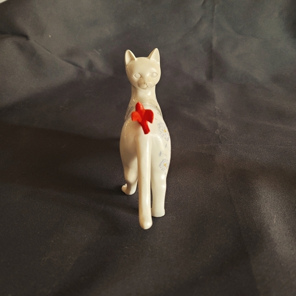 White Cat Looking Back at a Red Bird That Had Landed on His Back - Picture 3 of 12